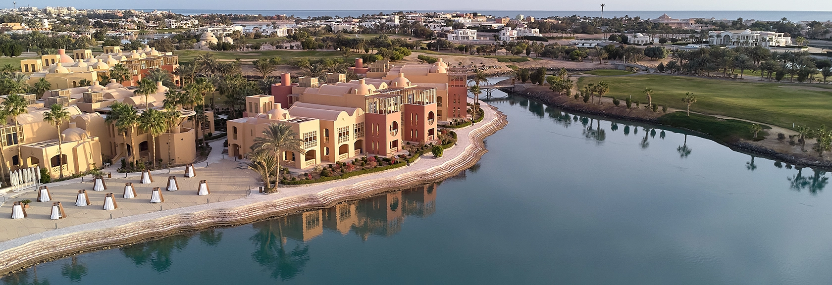 Aerial view of the Steigenberger Hotel at El Gouna, showcasing the expansive property with lush gardens, swimming pools, and proximity to the beach. The image highlights the hotel's layout and its beautiful surroundings, offering a comprehensive view of the resort’s facilities and location.