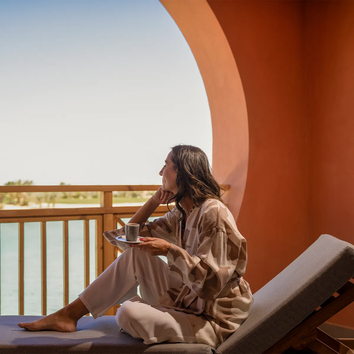 Woman enjoying beverage with a view